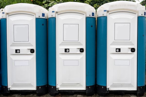 Porta potty delivery truck dropping off rental units in Doral